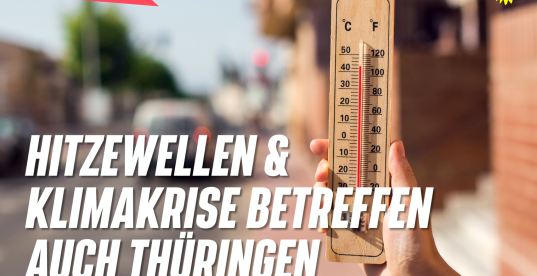 Bild mit Thermometer, das über 30 Grad an einer befahrenen Straße im Sommer anzeigt